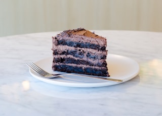 sliced chocolate cake beside fork on plate