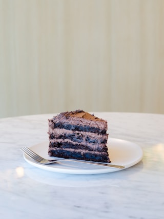 sliced chocolate cake beside fork on plate