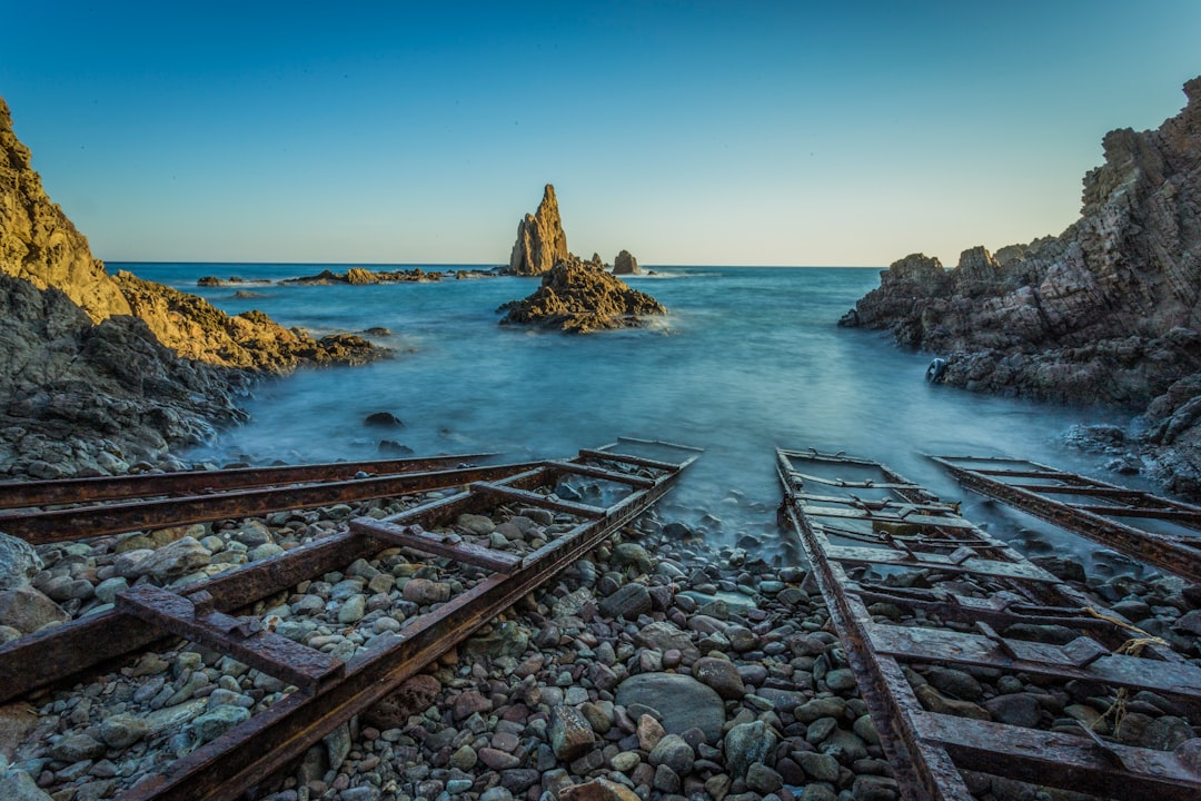 four brown wooden ladders on beach