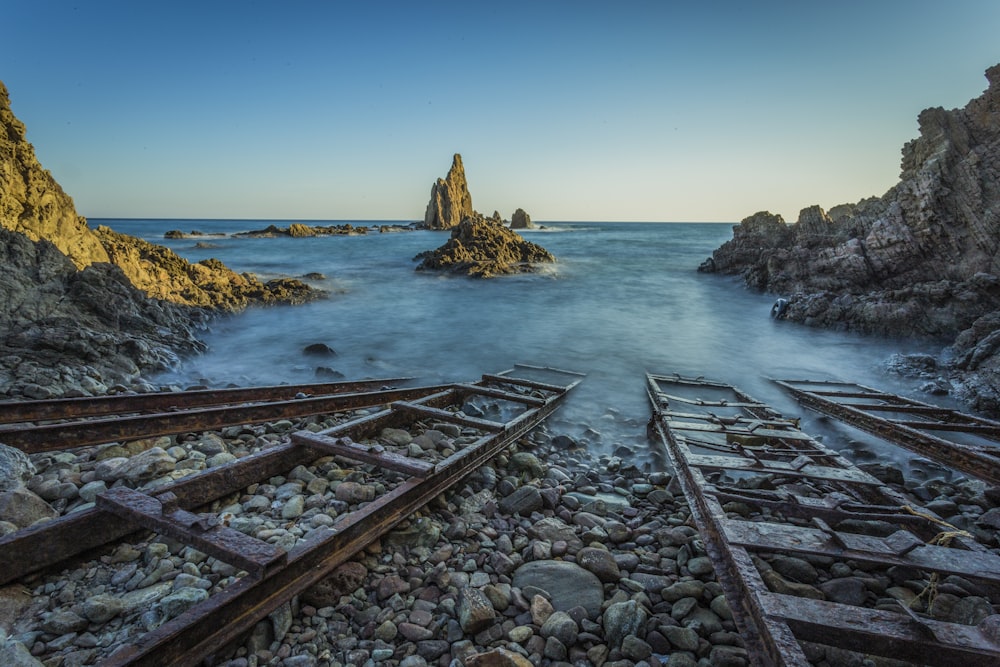 four brown wooden ladders on beach