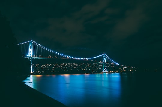 bridge with turned on blue string lights during nighttime in Stanley Park Canada