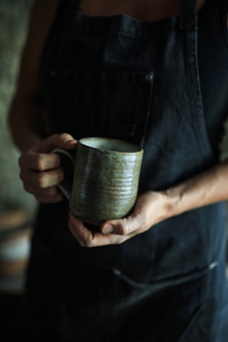person holding ceramic mug