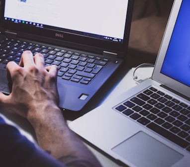 person using black laptop computer