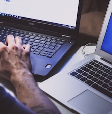 person using black laptop computer