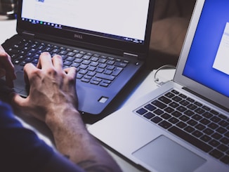 person using black laptop computer