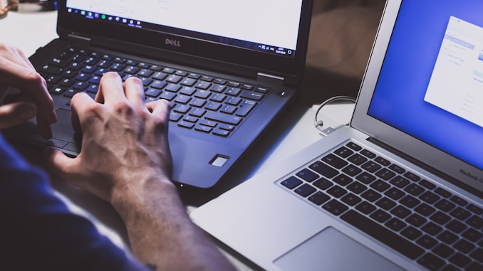 person using black laptop computer