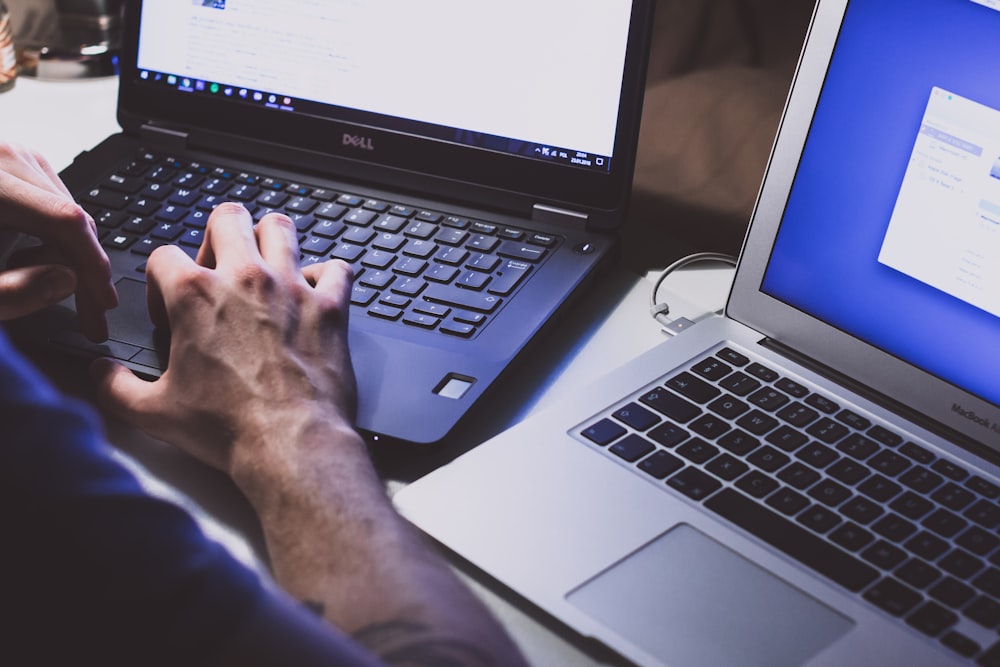 person using black laptop computer