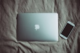 silver MacBook beside post-2014 iPhone