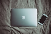 silver MacBook beside post-2014 iPhone