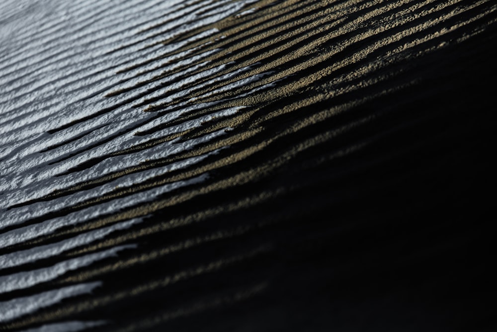 a close up of water ripples on the sand