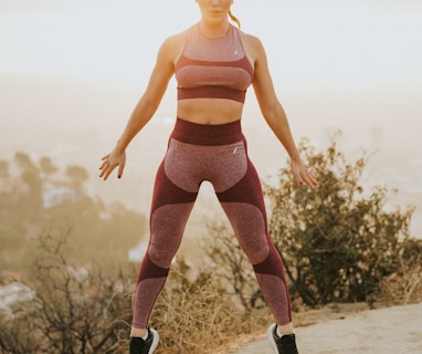 woman jumping above gray sand