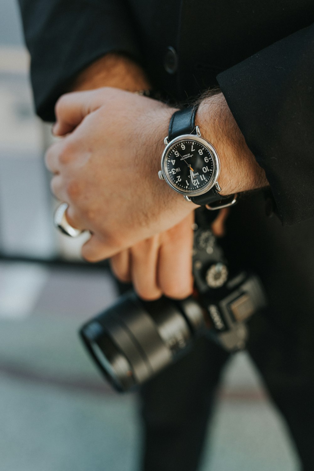 man wearing silver analog watch