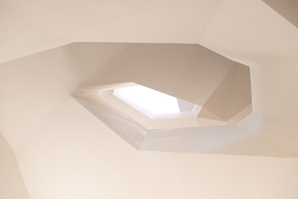 a white room with a skylight in the ceiling