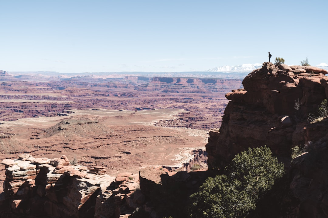 man standing on cliff,