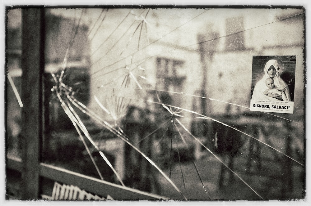 grayscale photo of broken mirror