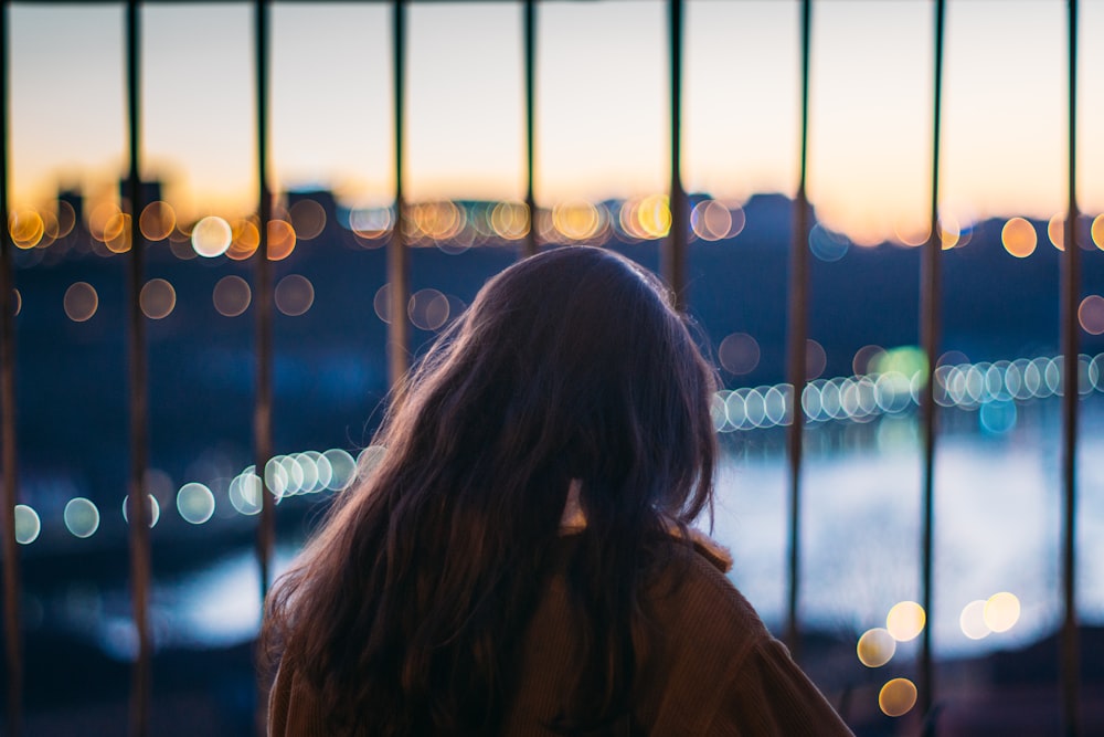 woman in front of curtain wall