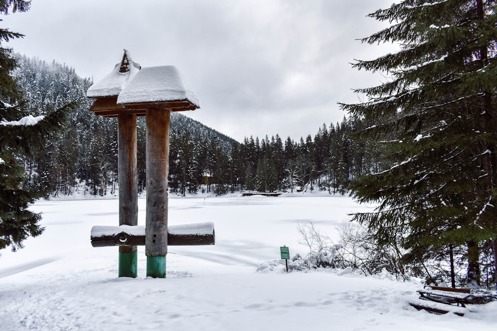 a snow covered park with benches and a gazebo