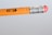 A close-up of the eraser end of a number 2 pencil with a silver ferrule and a red eraser.
