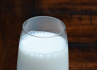 clear drinking glass with white liquid