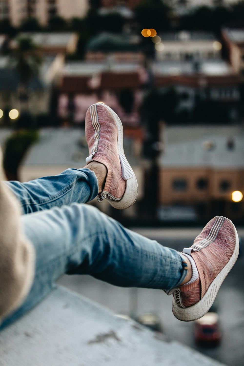 person wearing pair of brown sneakers swaying his feet