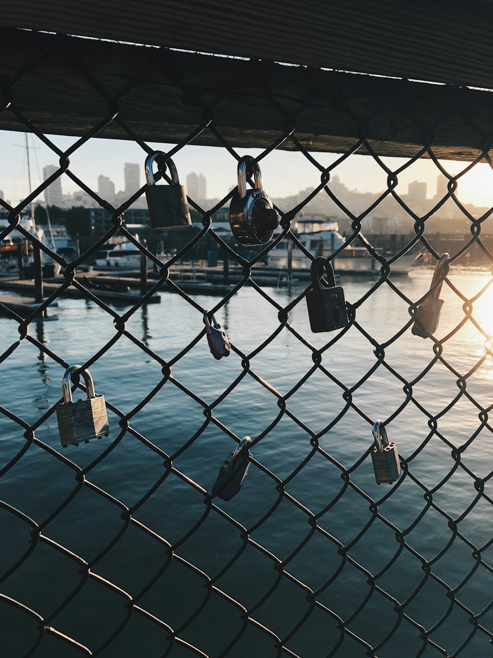 gray chain link with padlock over body of water