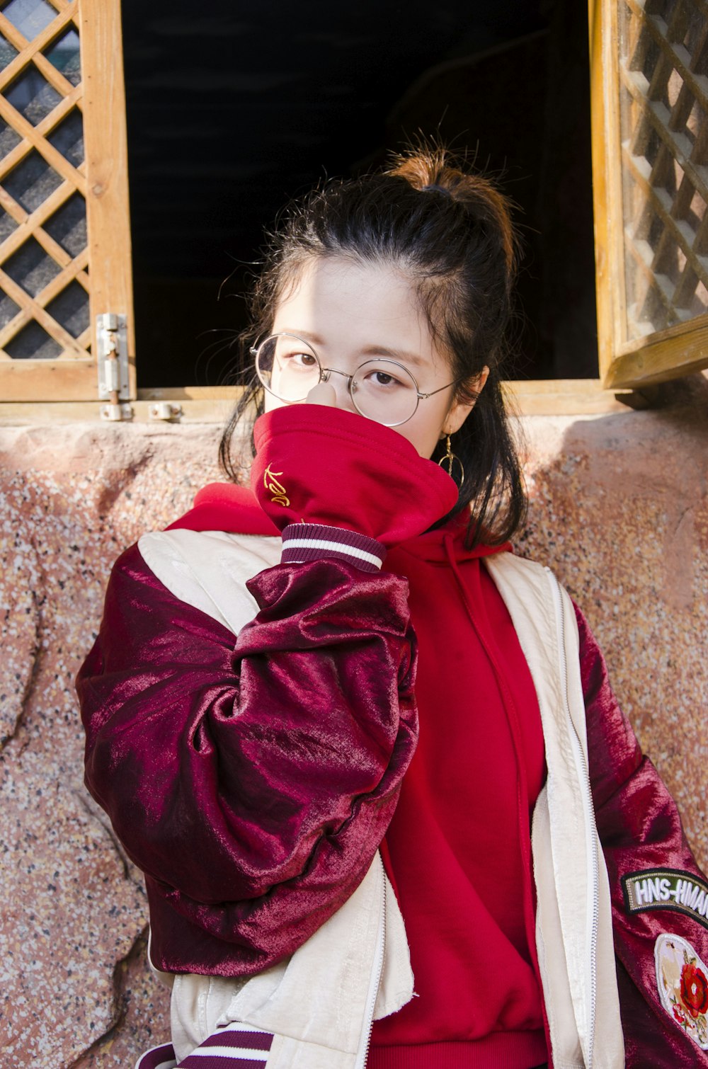 woman wearing red and white jacket