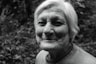 grayscale photo of smiling woman in crew-neck T-shirt