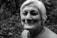 grayscale photo of smiling woman in crew-neck T-shirt