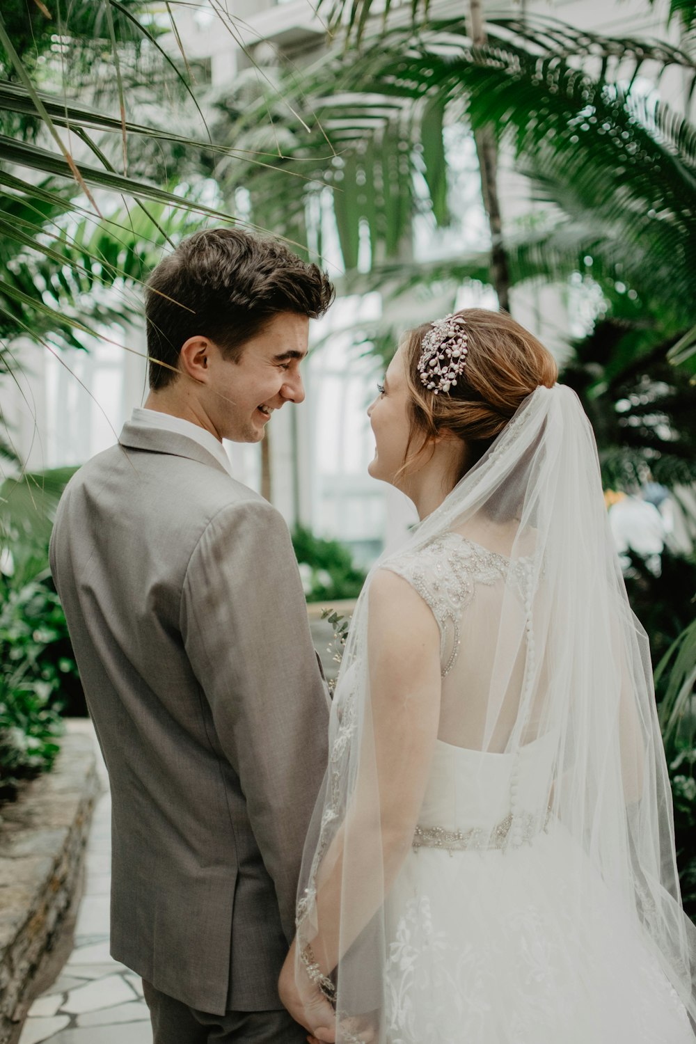bride and groom surrounded by plants
