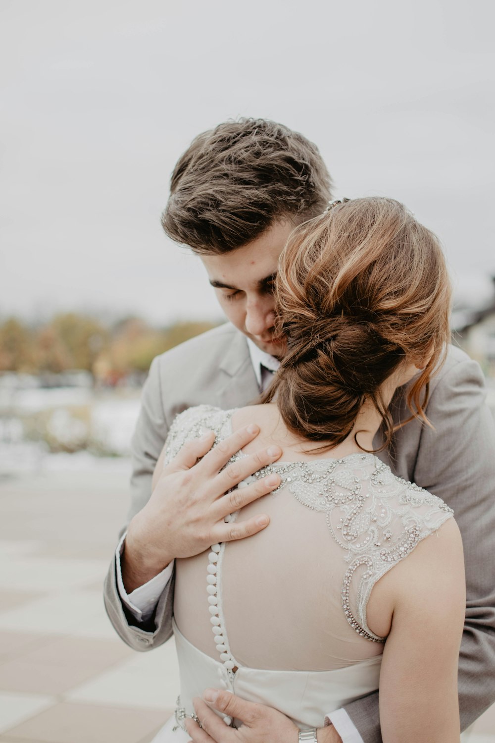 couple hugging under gray sky