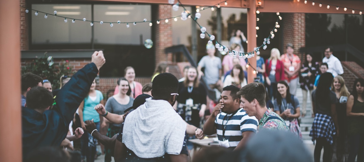 a group of people standing around each other