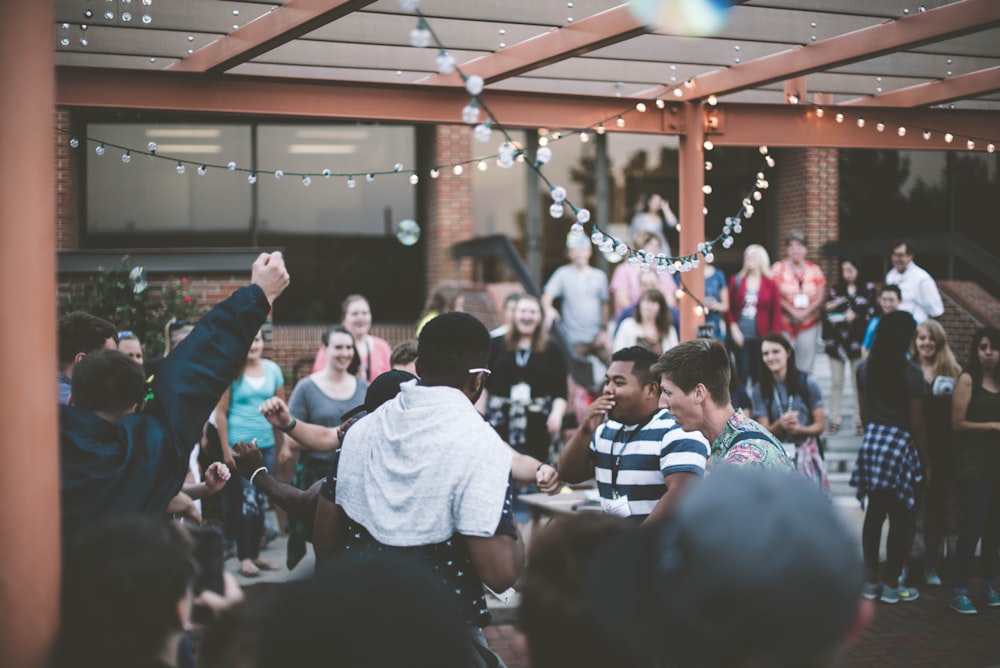 a group of people standing around each other