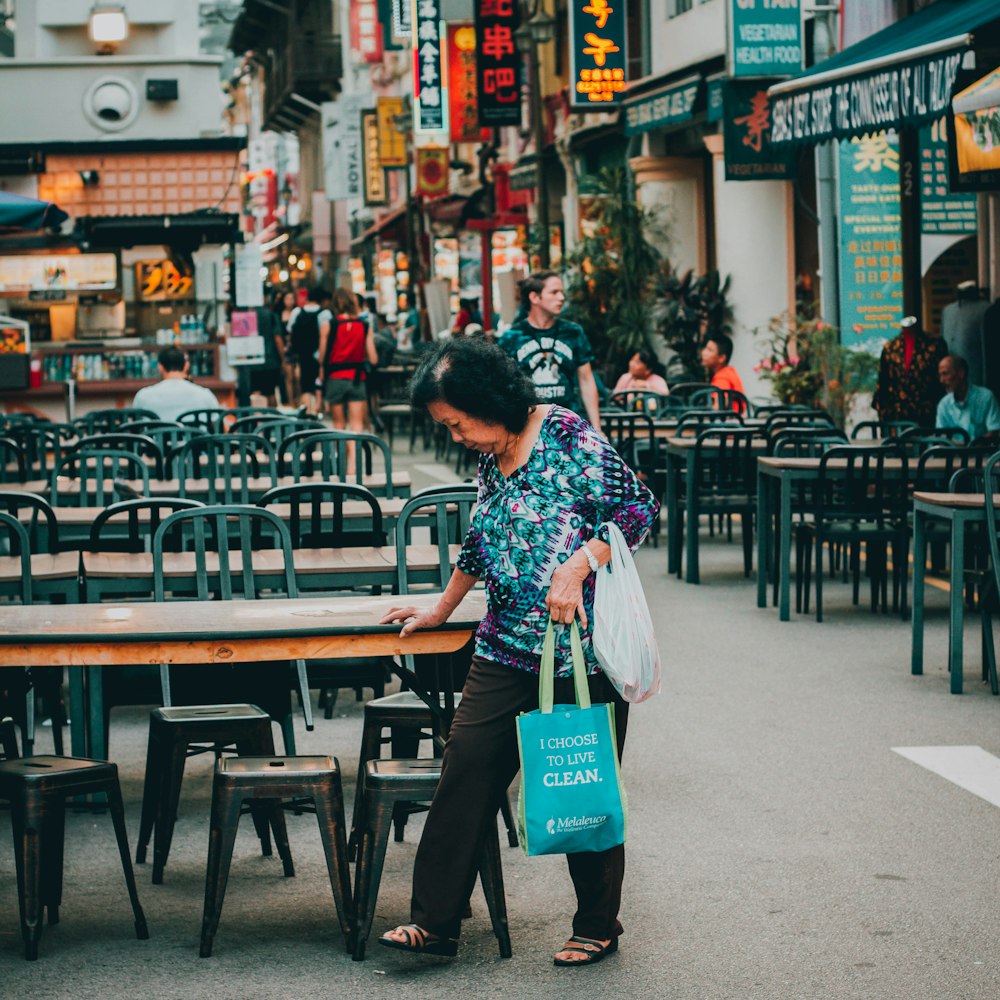 woman holding on table in cafe