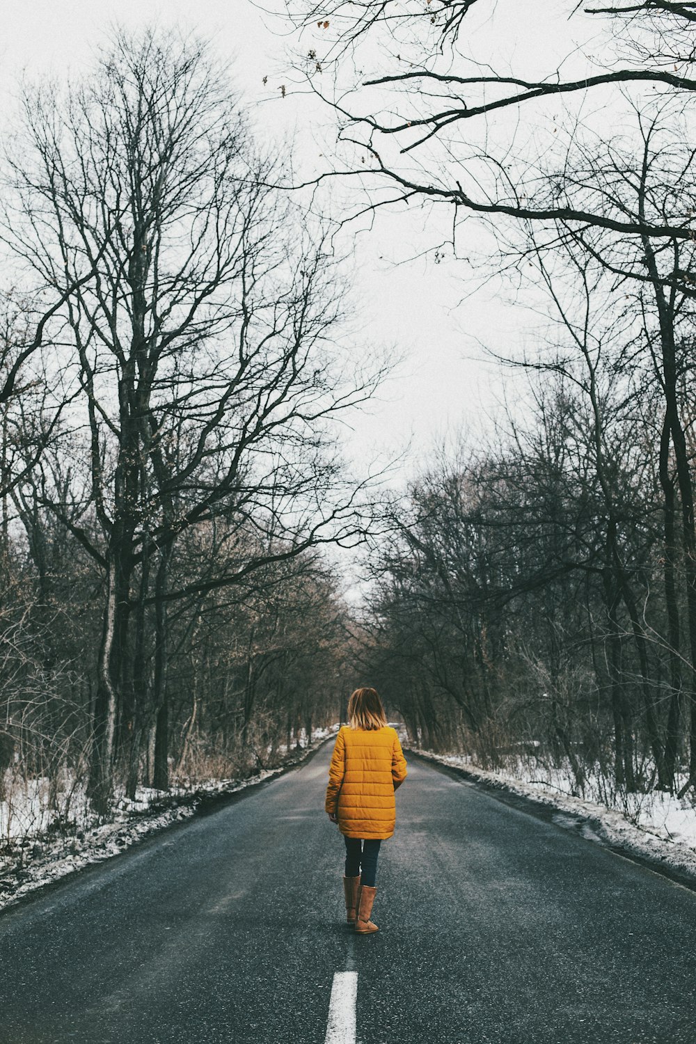 woman walking in the middle of road