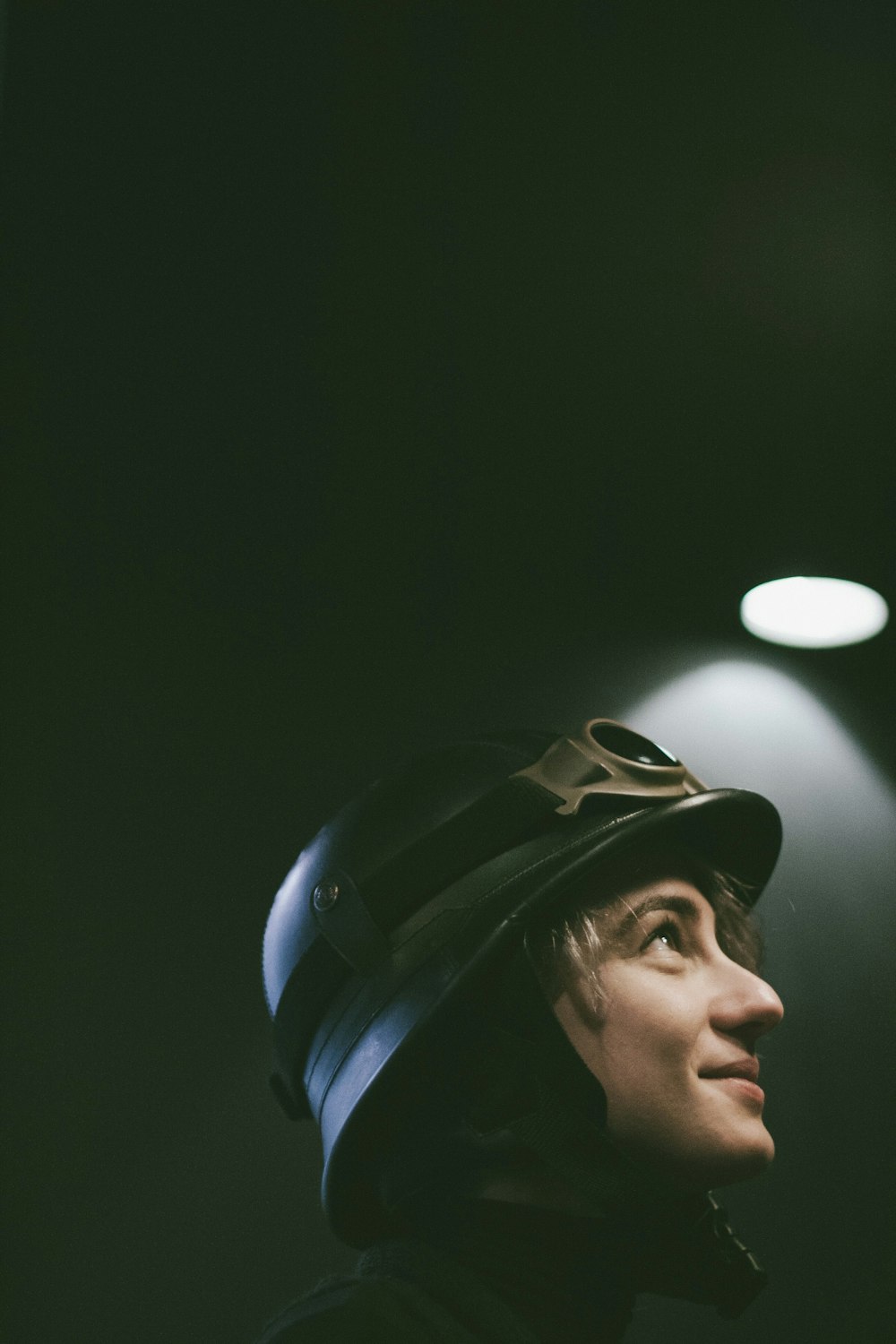 person wearing black hard hat looking up