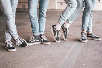 people wearing black Vans Old Skool