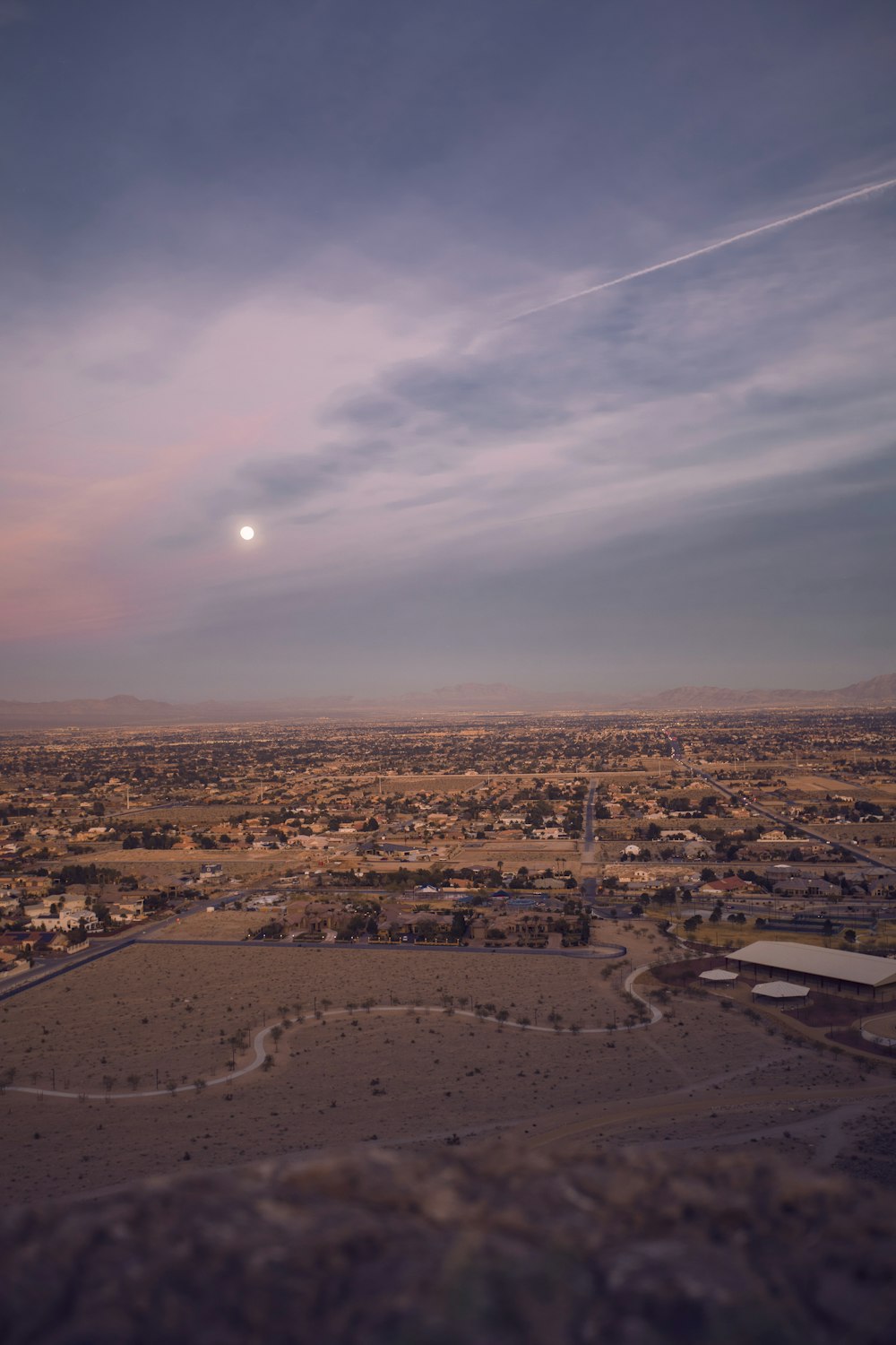 aerial photography of brown fields with houses under sun during daytime