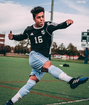 man wearing black and blue jersey shirt on field