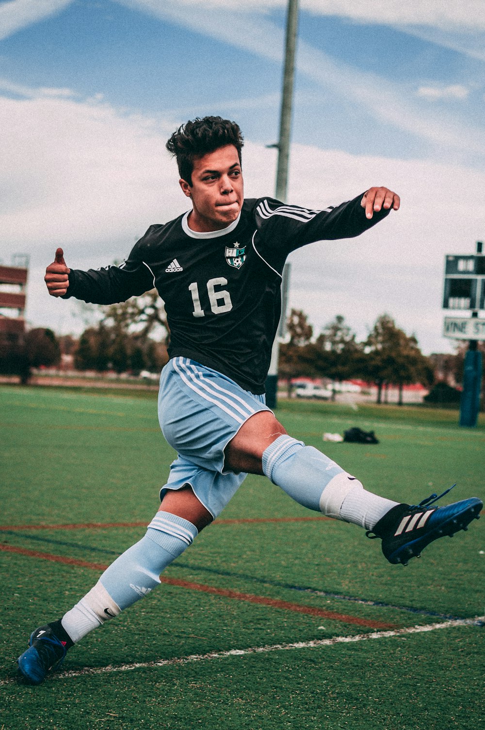 man wearing black and blue jersey shirt on field