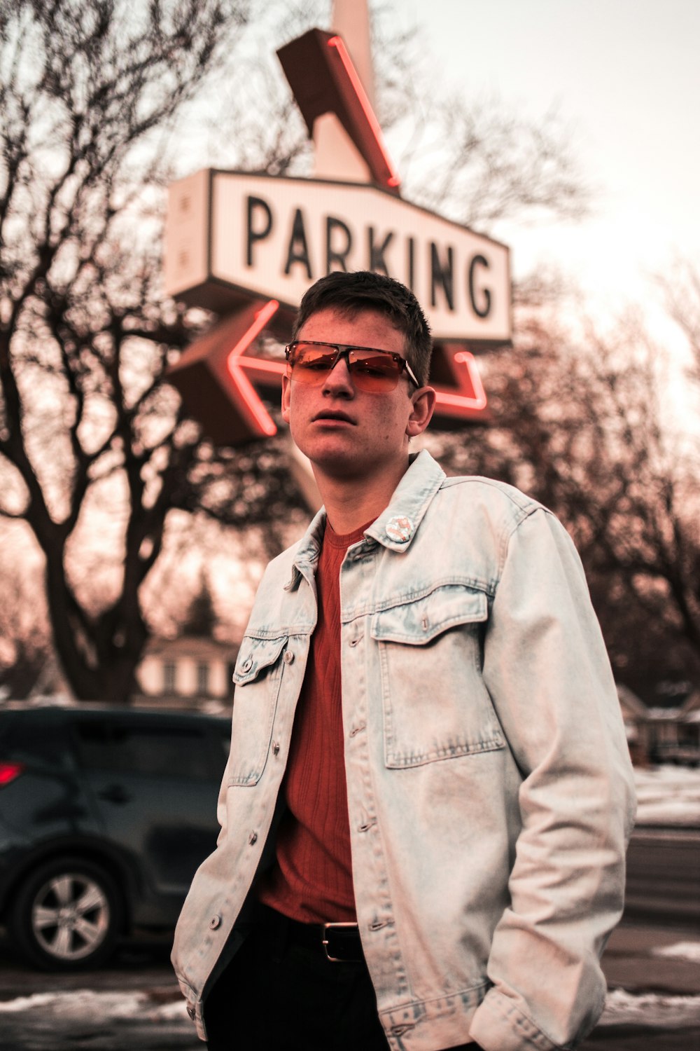 man standing in front of parking signage