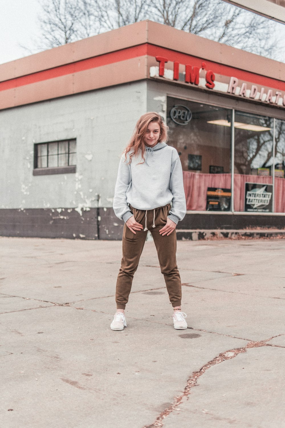 woman standing on gray concrete surface during daytime