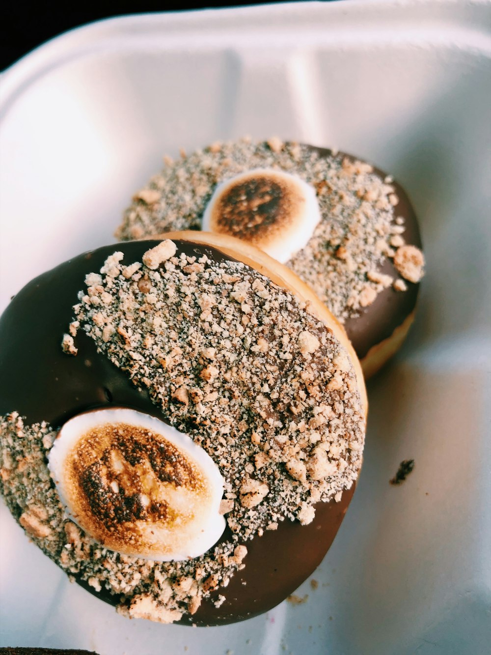 dois donuts com cobertura de chocolate na tigela