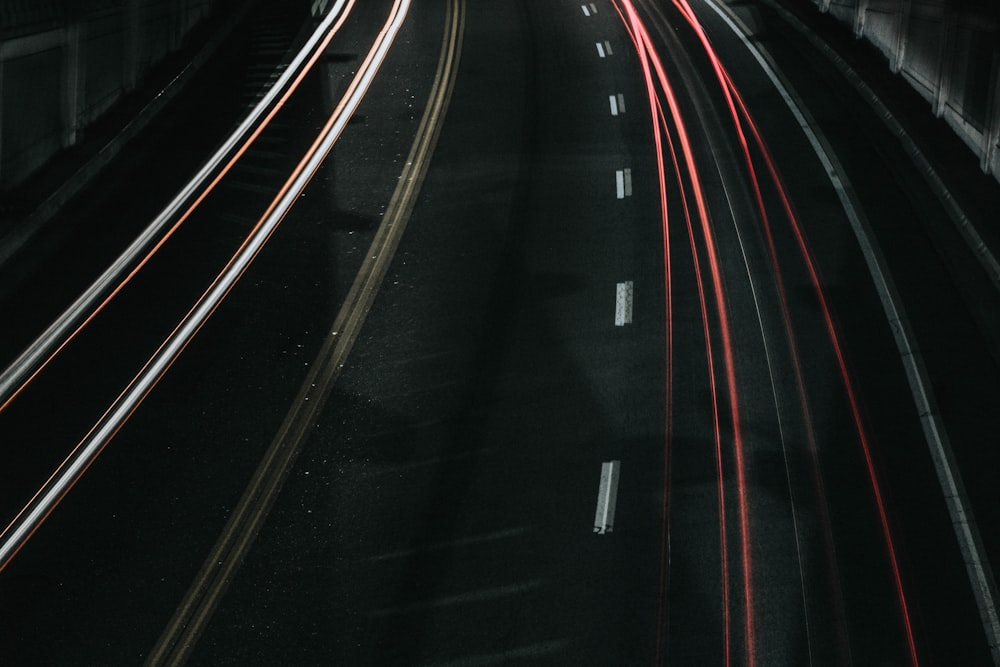 time lapse photo of vehicle passing through road