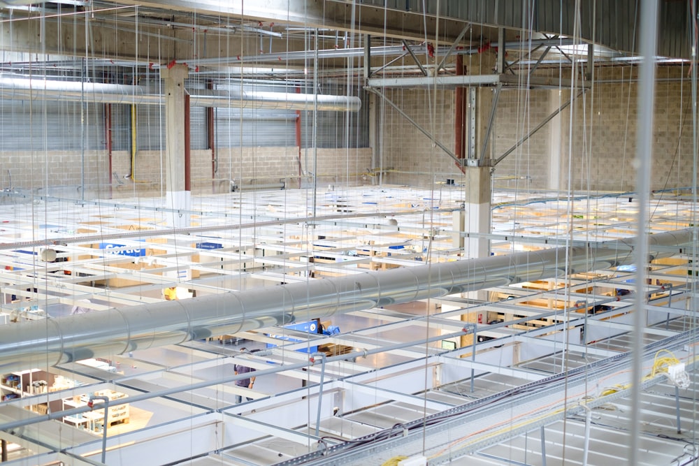 white and blue airplane in a factory