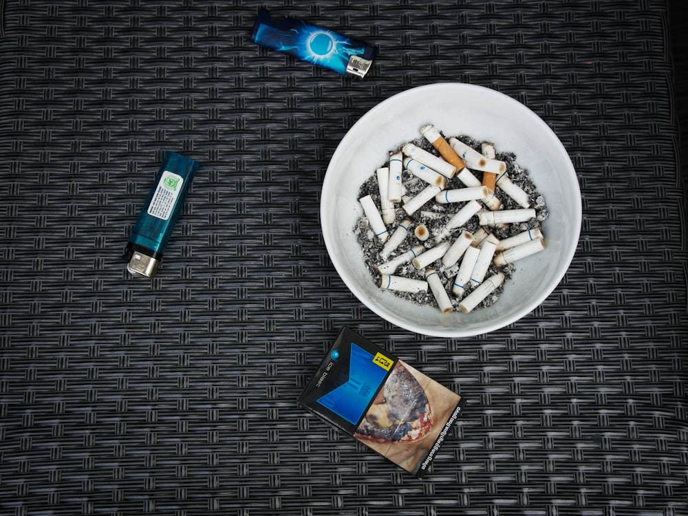 white cigarette in white ceramic bowl