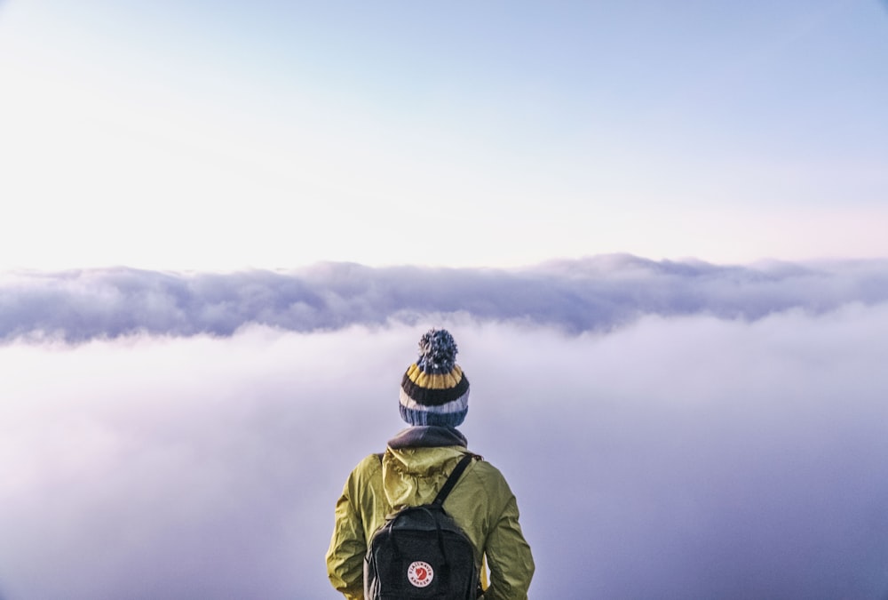 person looking thru sea of clouds