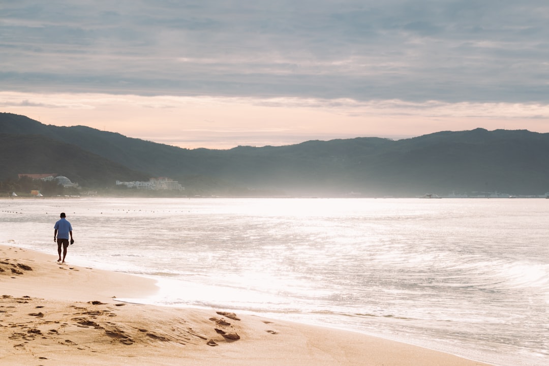 man walking in the seashore