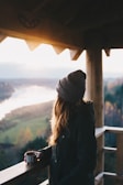 Couple enjoying a morning coffee on the balcony of a chalet surrounded by nature.