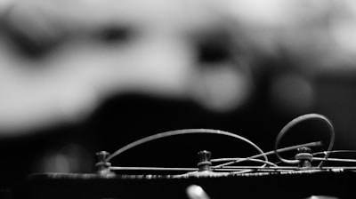 Close-up shot of Marcos Magalhães tuning his guitar backstage before a show.