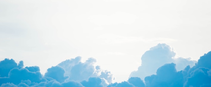 blue clouds under white sky